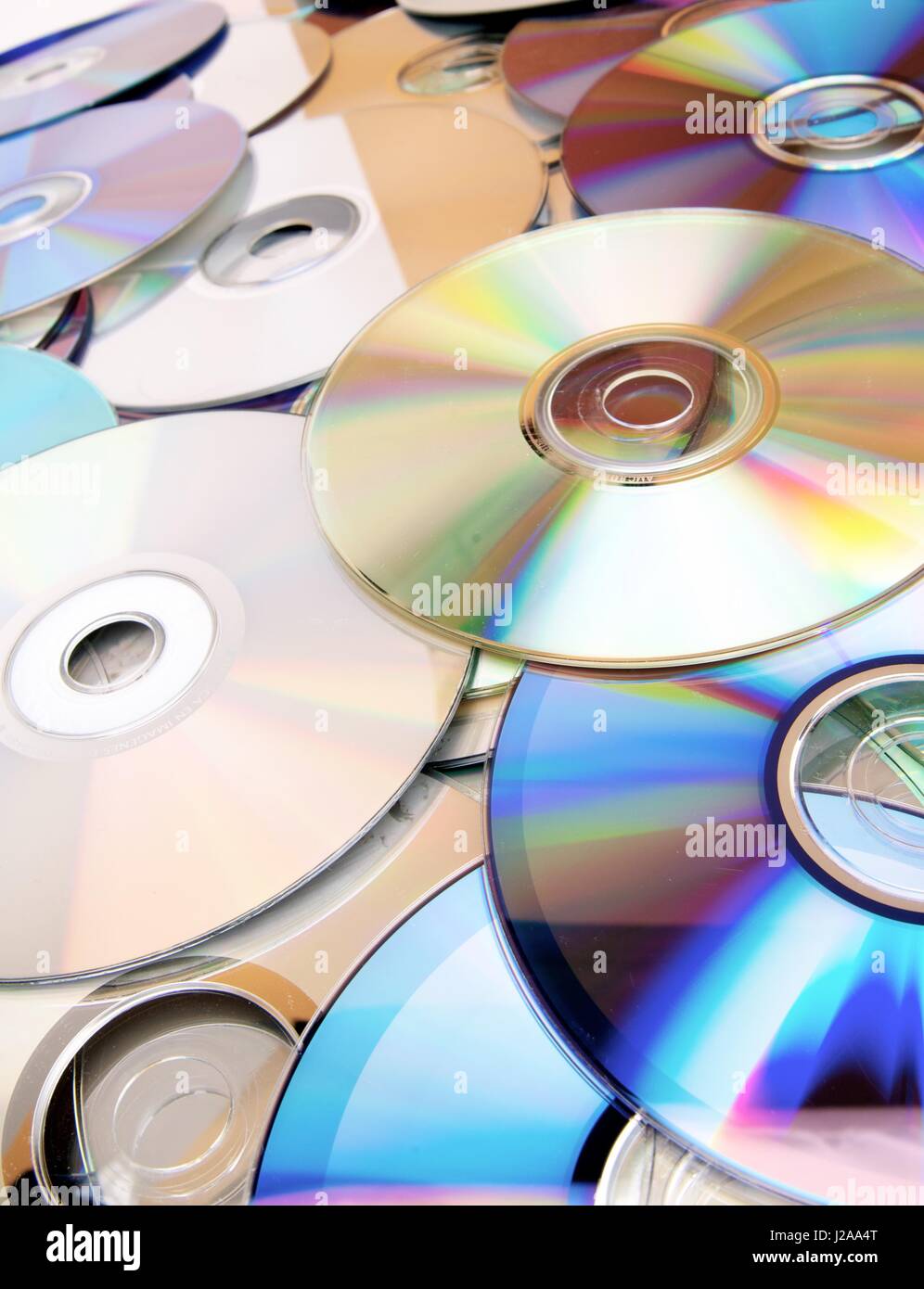Given a set of DVDs scattered on a table Stock Photo