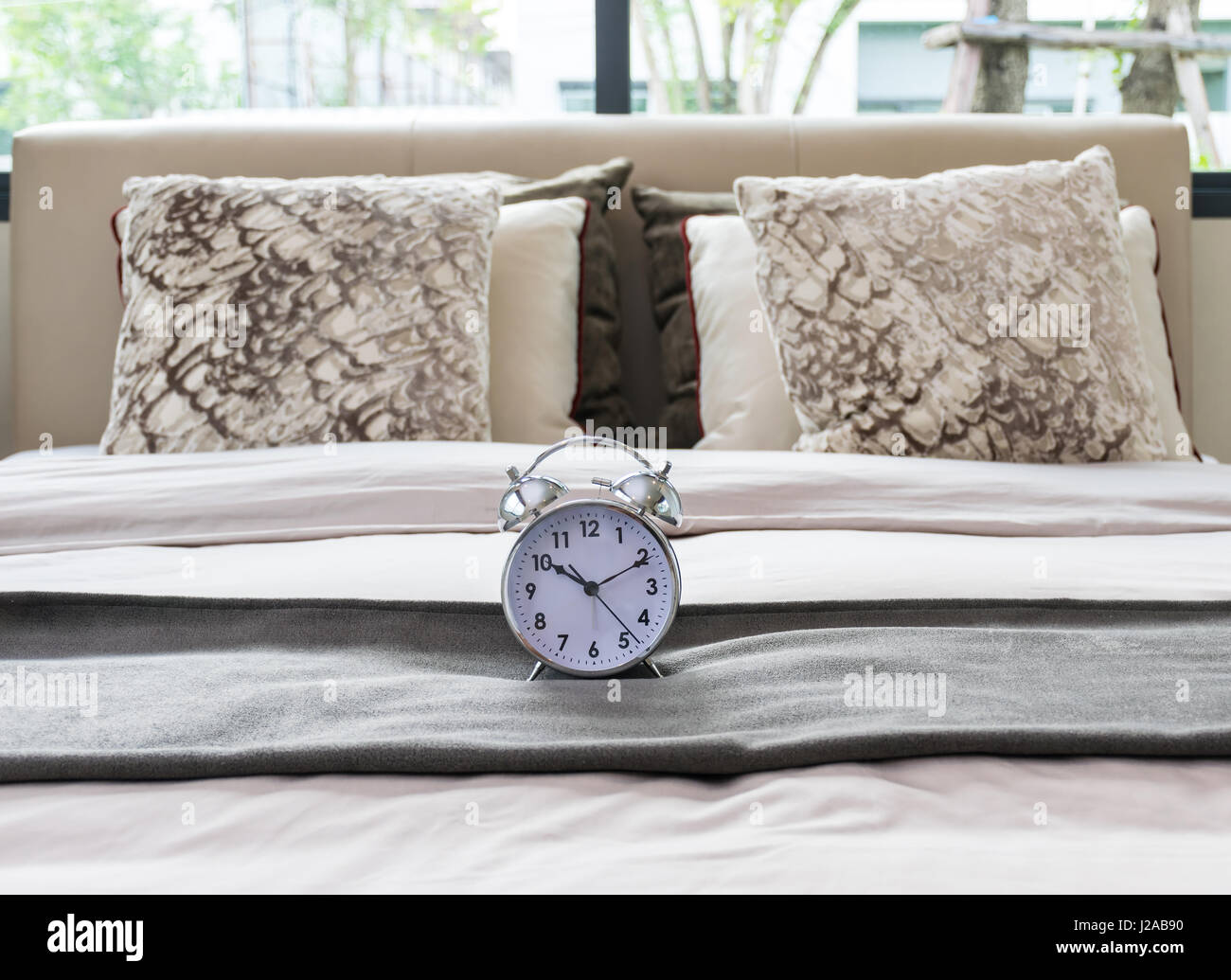classical alarm clock on bed Stock Photo Alamy