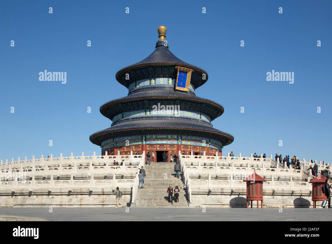 China, Beijing, Tourists climbing stairs of Hall of Prayer for Good Harvest at Temple of Heaven Park on sunny autumn afternoon Stock Photo