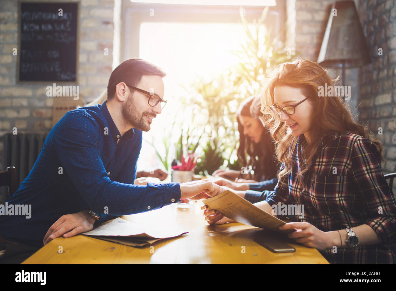Group of happy business people eating together in restaurant Stock Photo