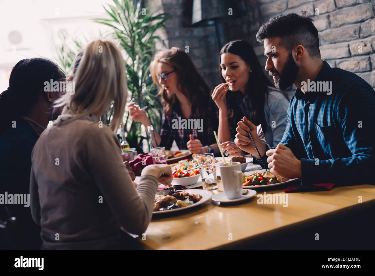 Group of happy business people eating together in restaurant Stock Photo