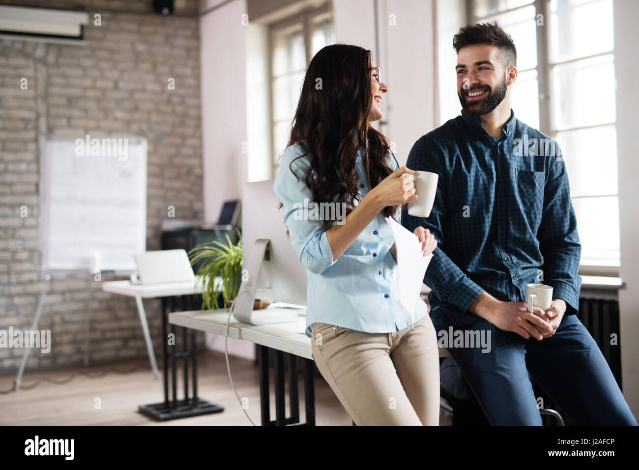 Coworking colleagues having conversation at workplace and sharing ideas Stock Photo