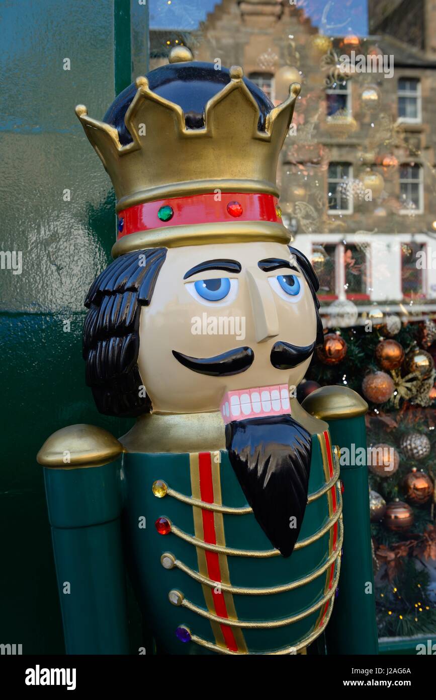A large nutcracker Christmas figurine standing outside a shop