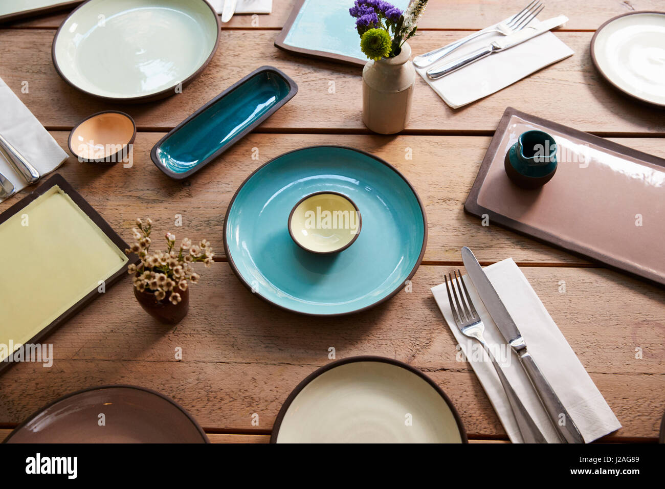 High angle view of earthenware and cutlery on a table Stock Photo