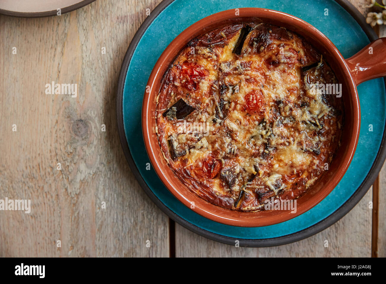 Aubergine, feta and tomato bake in dish, overhead shot Stock Photo