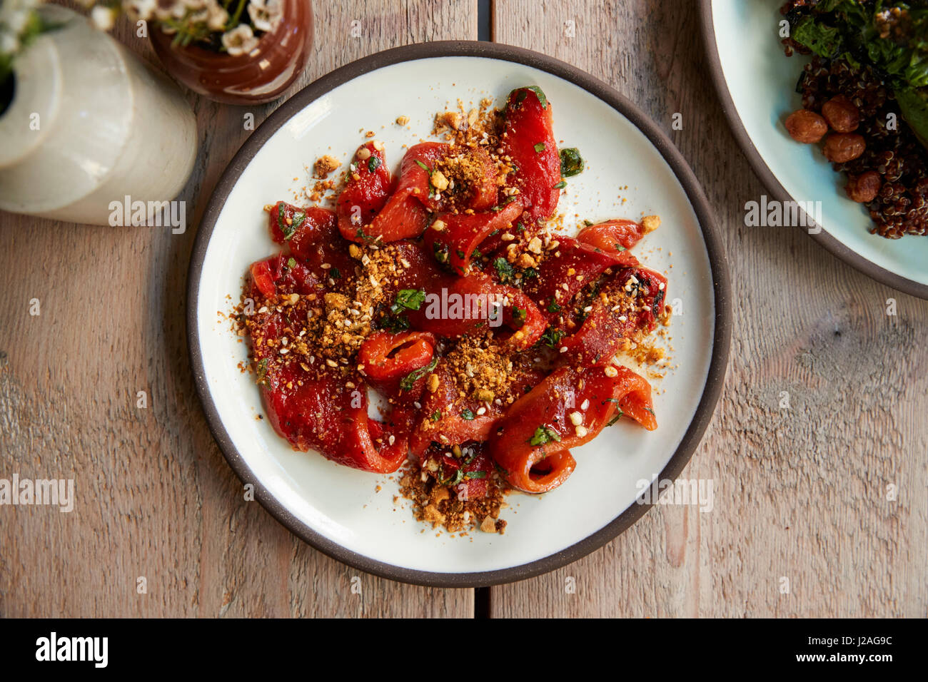 Marinated, flamed peppers with dukkah spices, overhead view Stock Photo