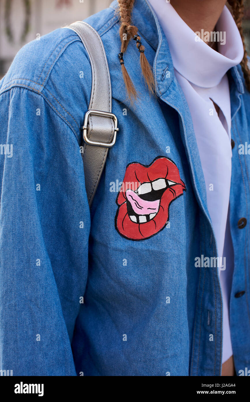 LONDON - FEBRUARY, 2017: Mid section of woman wearing decorated denim shirt in street during London Fashion Week Stock Photo