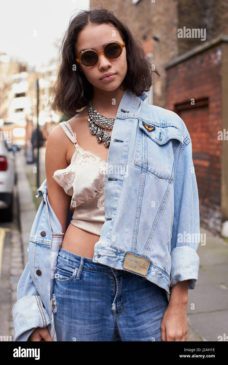 LONDON - FEBRUARY, 2017: Waist up portrait of fashion model Edie Rose dressed in denim and camisole in the street outside Sharon Wauchob show, London Fashion Week, day four. Stock Photo