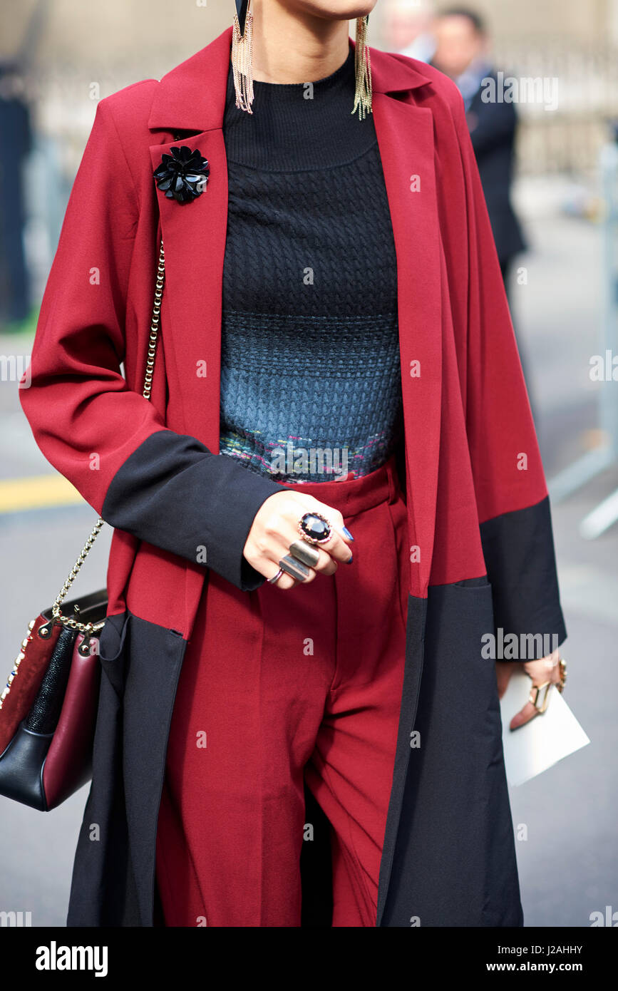 Woman in street wearing red suit with long jacket, crop Stock Photo