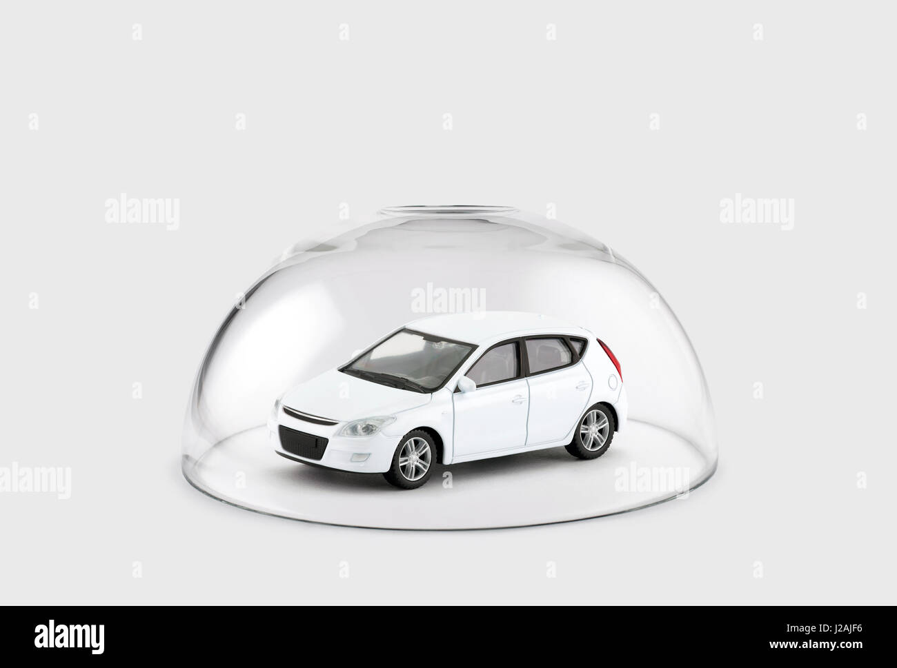 White car protected under a glass dome Stock Photo