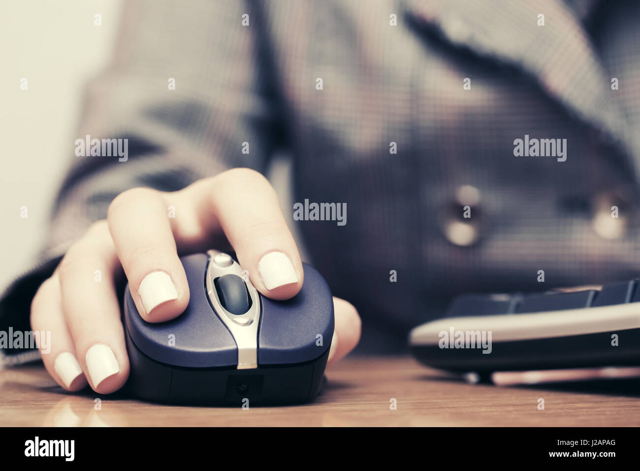 Woman using computer mouse and keyboard Stock Photo - Alamy