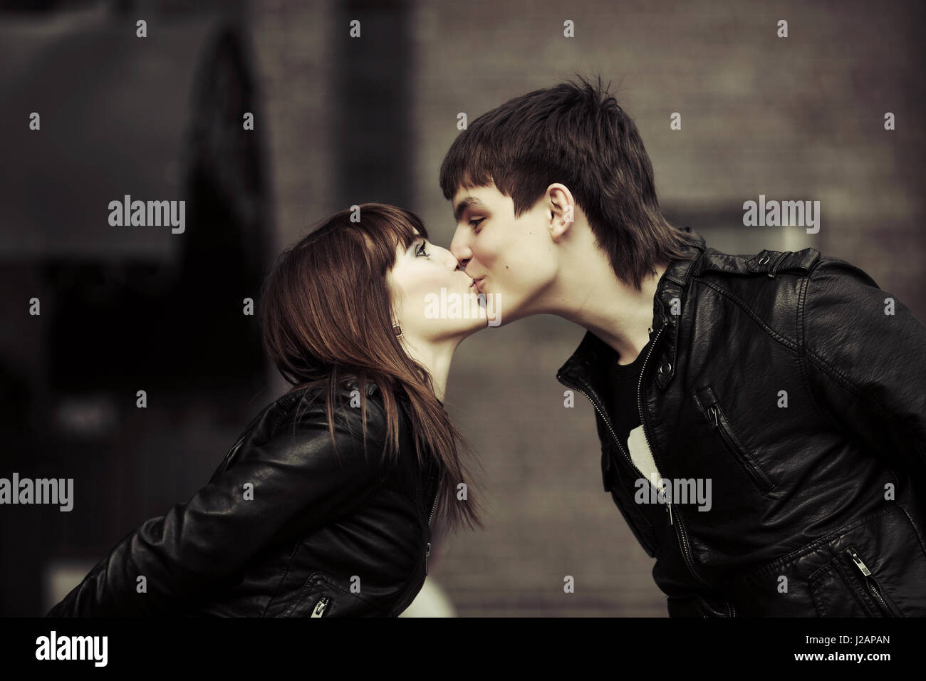 Happy young couple kissing on the city street Stock Photo - Alamy