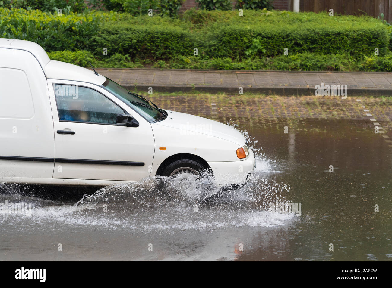 car drives through a flooded street Stock Photo - Alamy