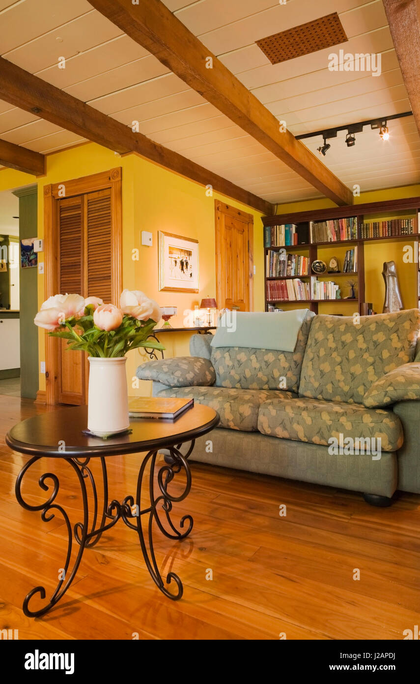 Sofa and round coffee table in the living room inside a stacked log home Stock Photo Alamy