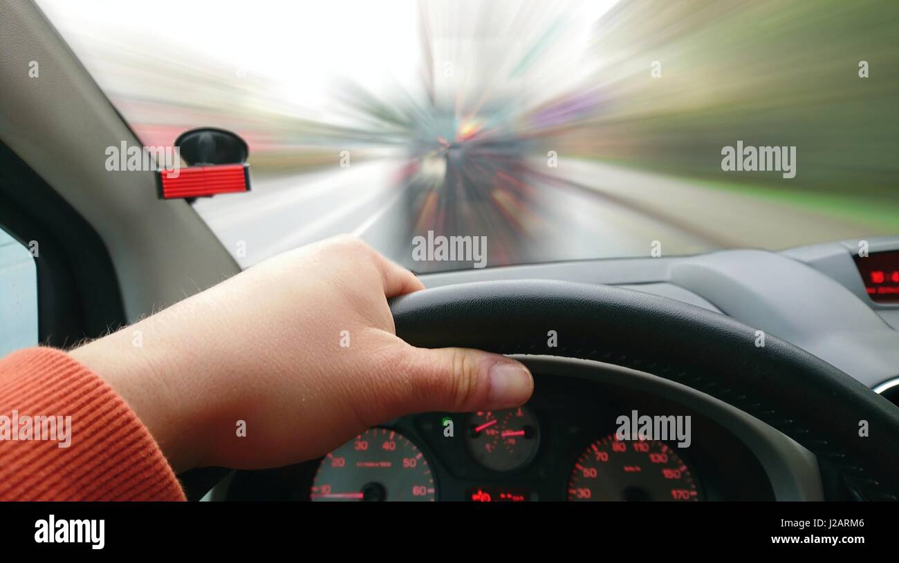 First Person View of Driver Behind the Wheel During Driving a Car. Point of View Shot of Driving a Car. Drivers POV shot. Stock Photo