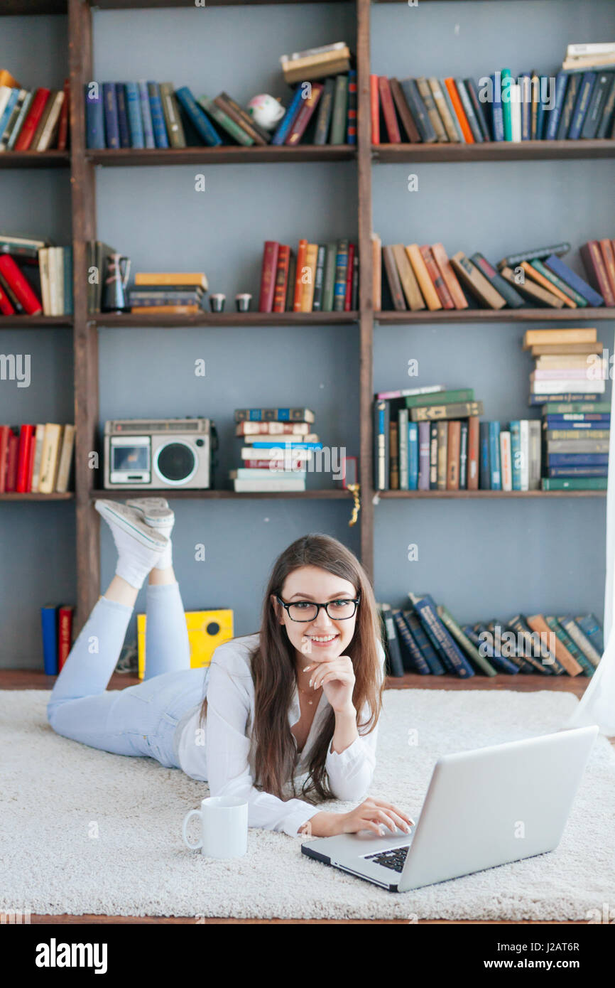 The Young Beautiful Woman Lying on the Floor with Laptop Stock Photo ...