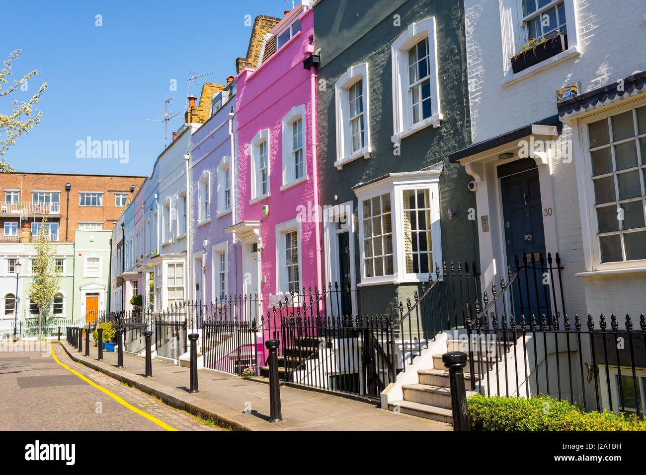 Pastel colored restored Victorian British houses in an elegant mews in