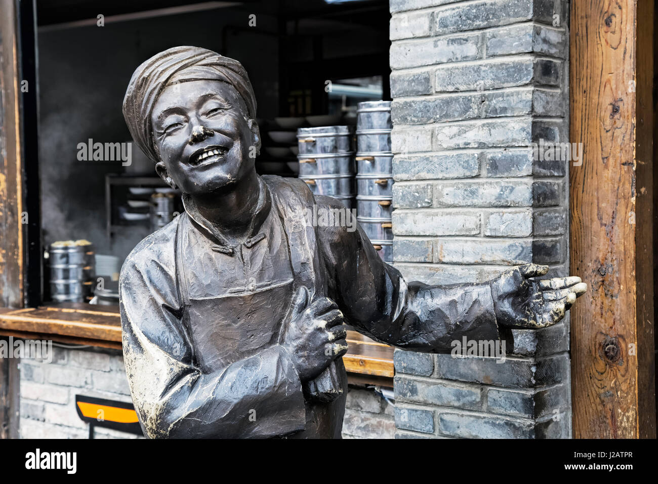 Statue welcoming tourists into a restaurant along the famous Kuanzhai Alleys in Chengdu, Sichuan province, China Stock Photo