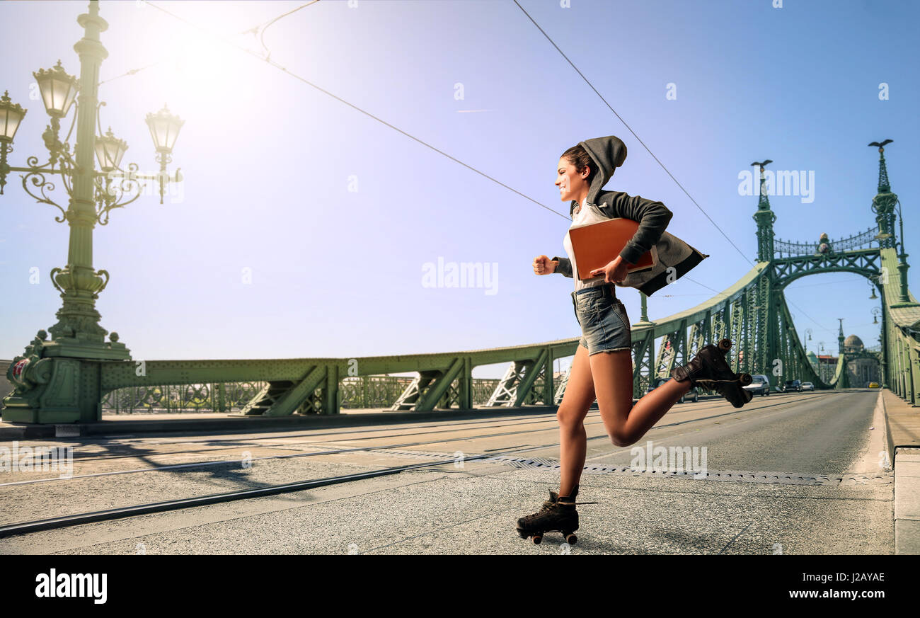 Woman running on bridge Stock Photo