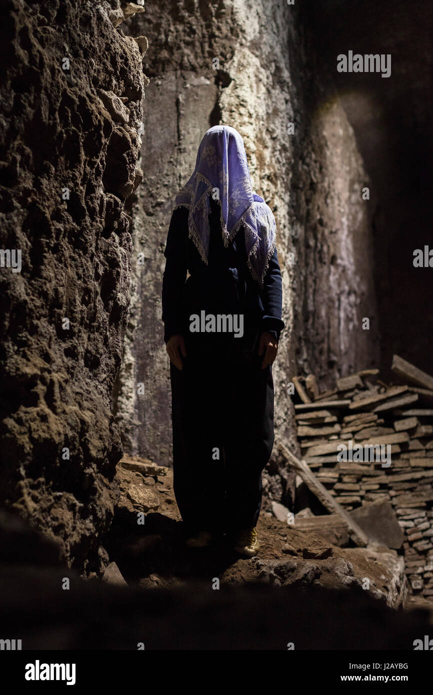 Full length of woman with obscured face standing in cave Stock Photo