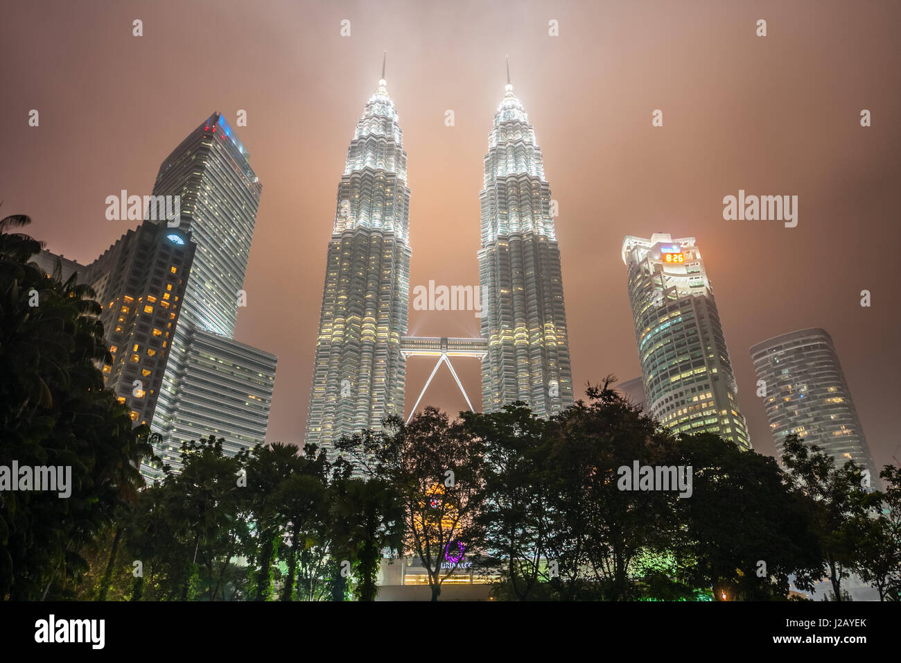 Petronas Twin Towers at hazy night. With 452 meters, the Petronas Twin Towers are the tallest twin buildings in the world. Kuala Lumpur, Malaysia. Stock Photo