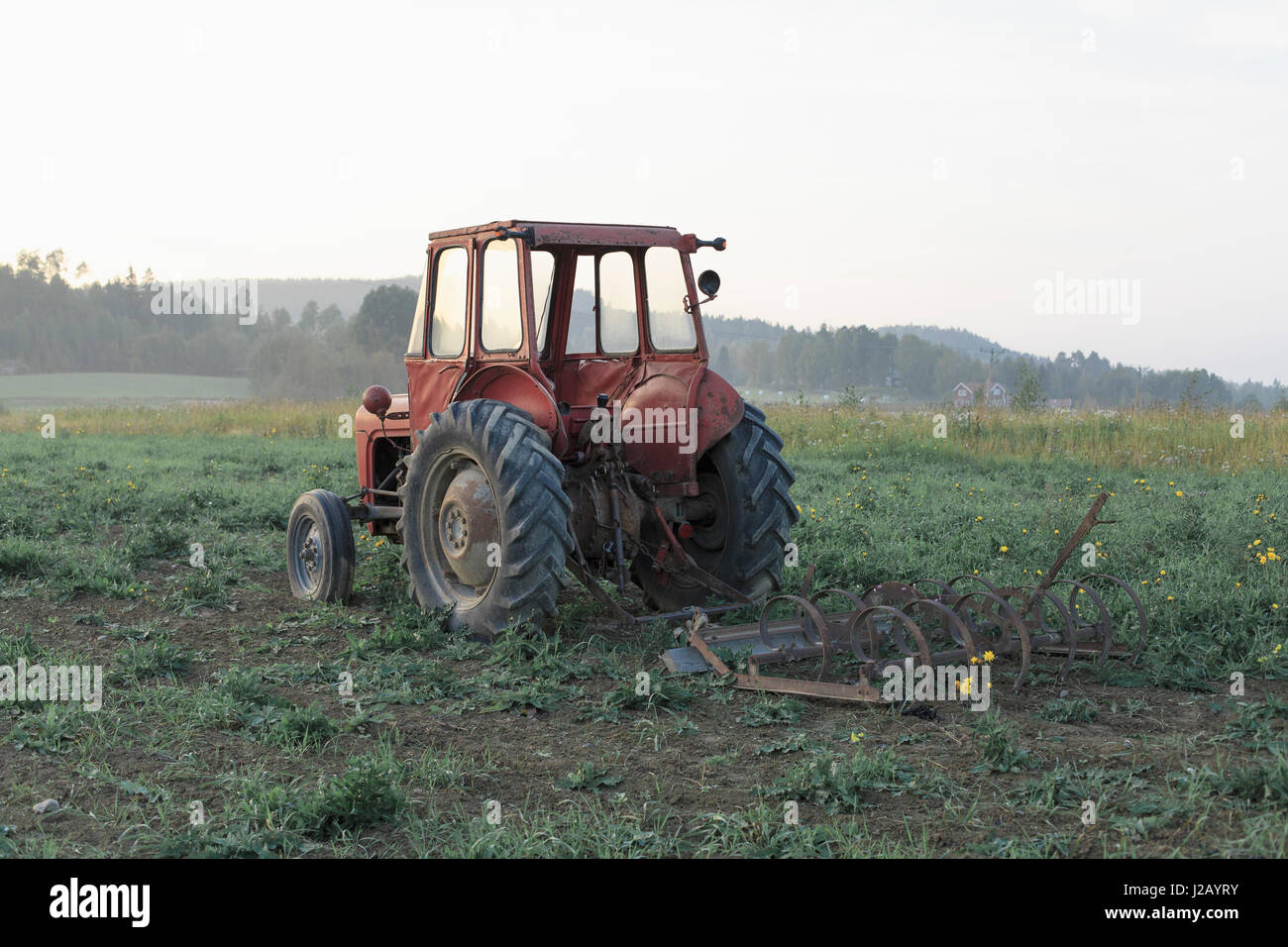Abandoned tractor on field against clear sky Stock Photo - Alamy