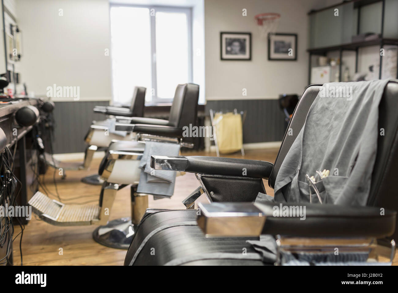 Row of empty chairs at barber shop Stock Photo