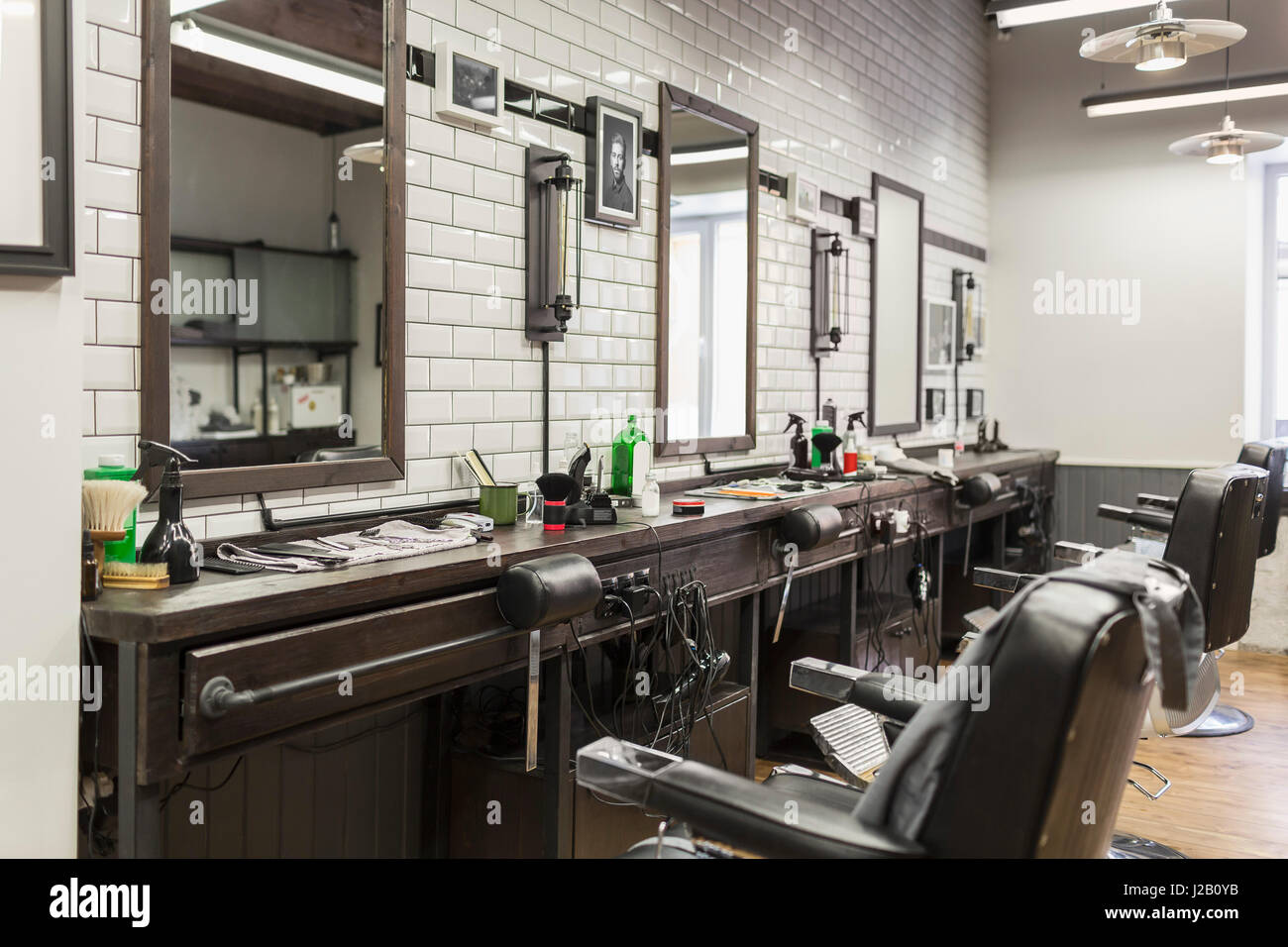 Empty chairs in front of mirrors at barber shop Stock Photo Alamy