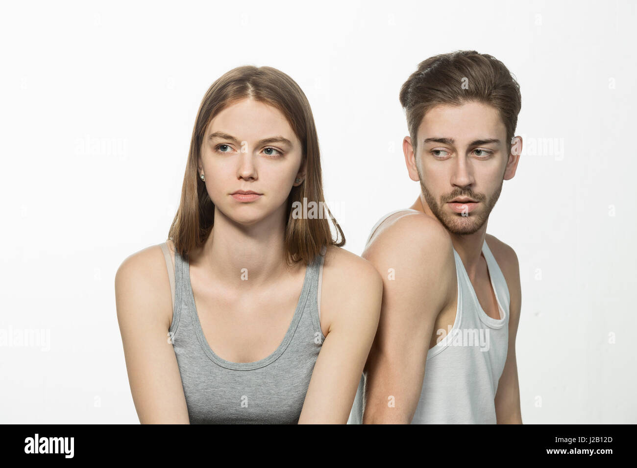 Man looking at upset woman against white background Stock Photo
