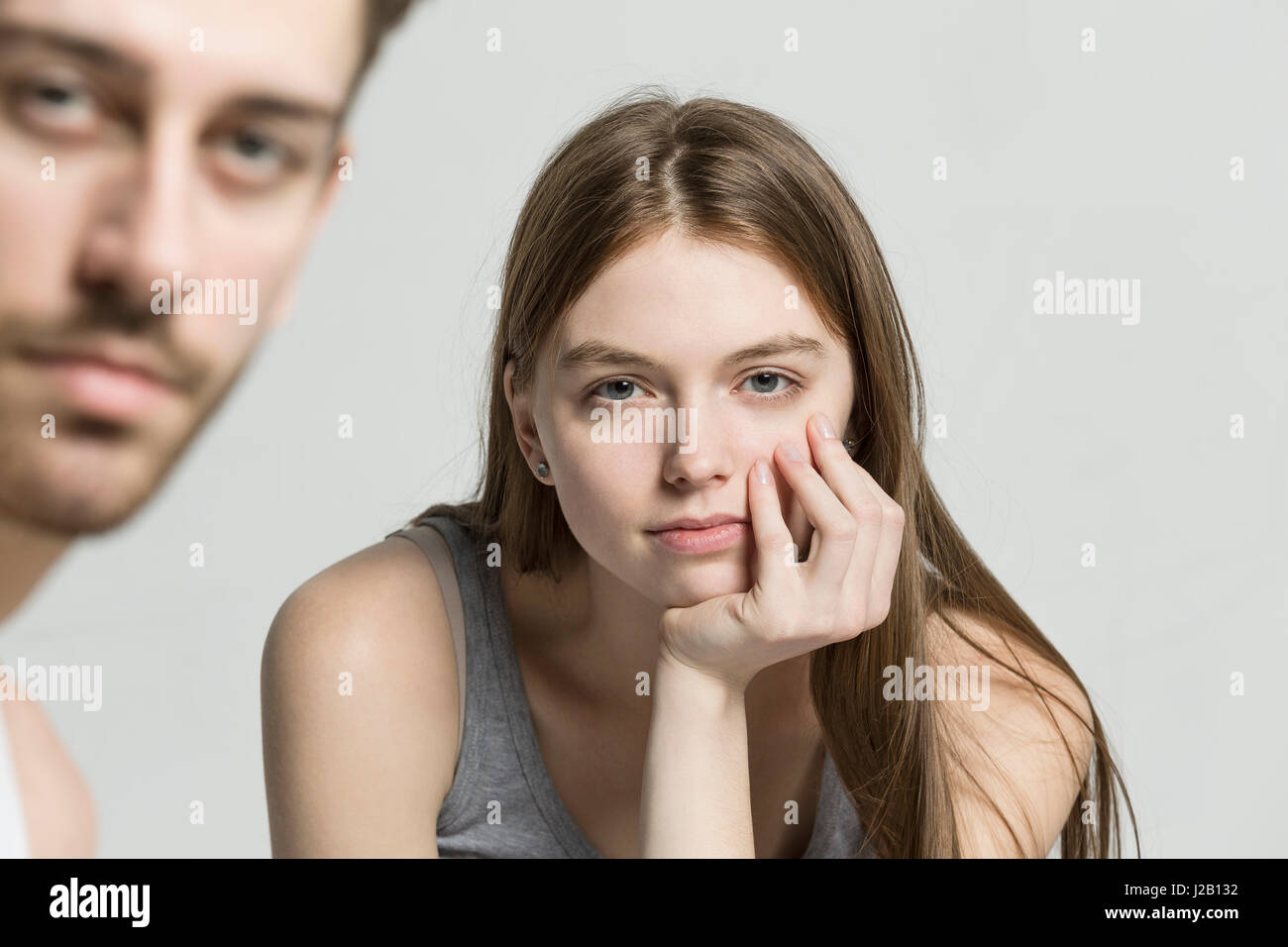 Portrait of man and woman against gray background Stock Photo