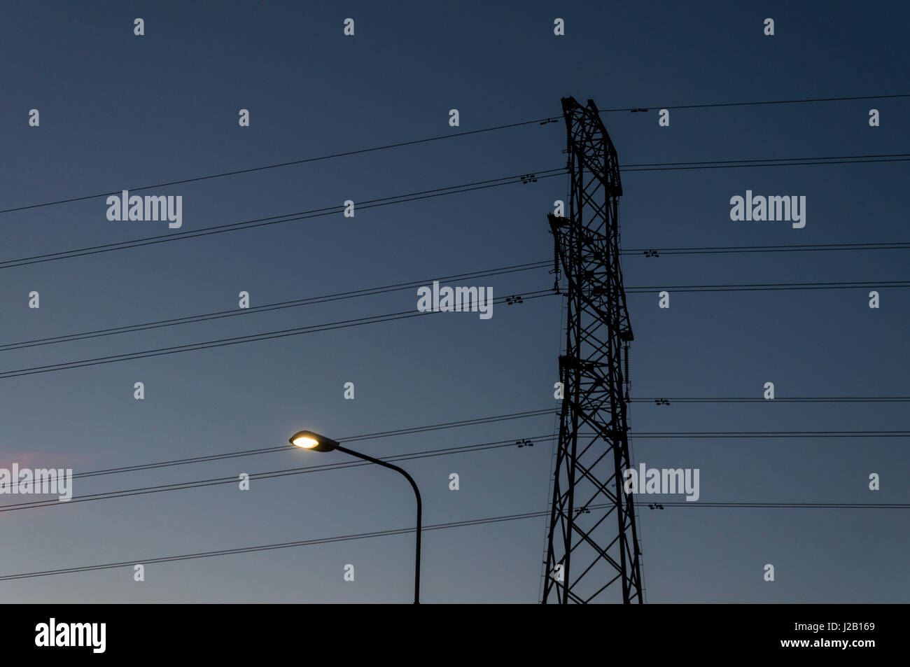 Electricity power cables pylon light street lighting energy. Stock Photo