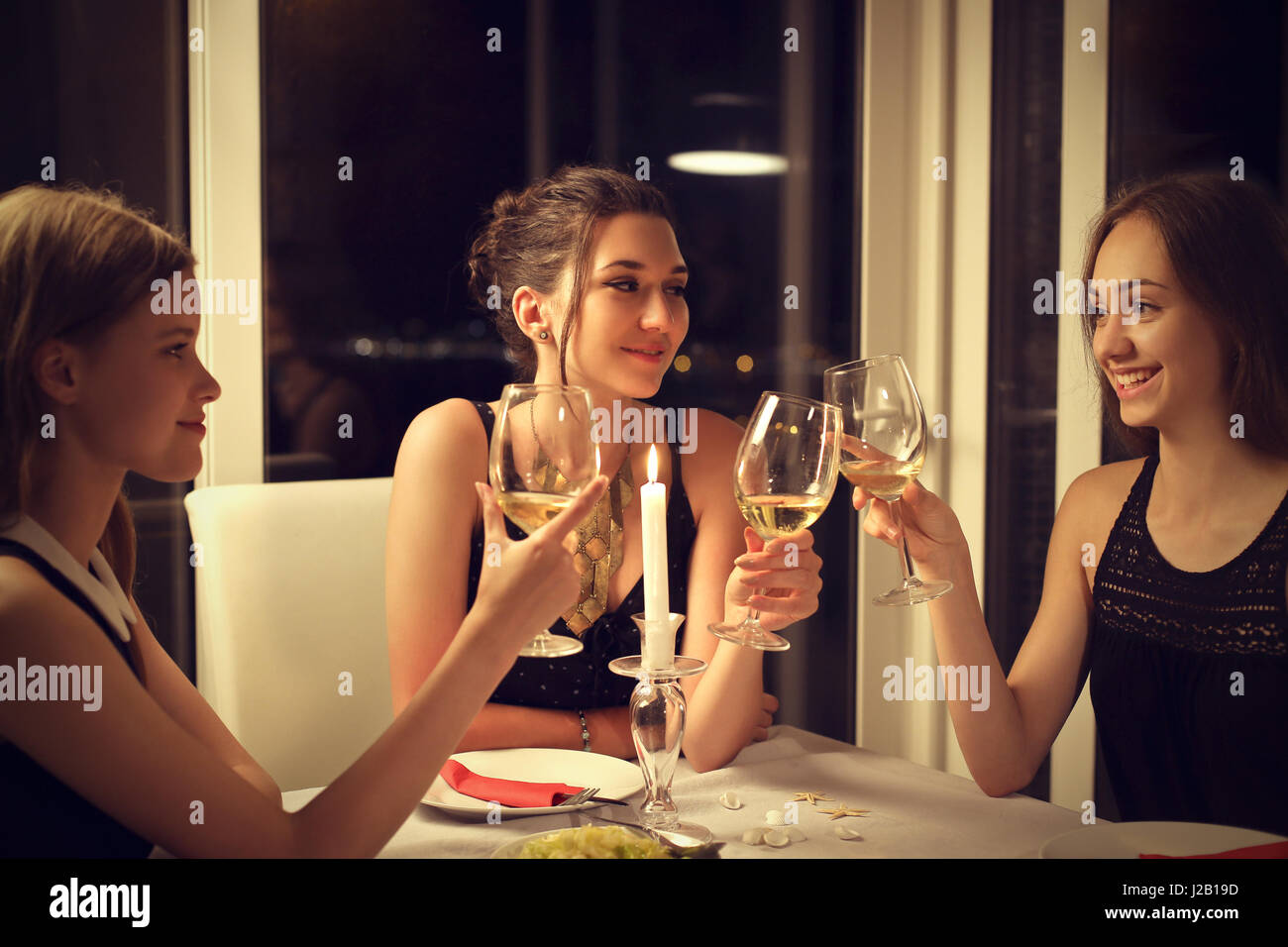 3 young women toasting with champagne Stock Photo