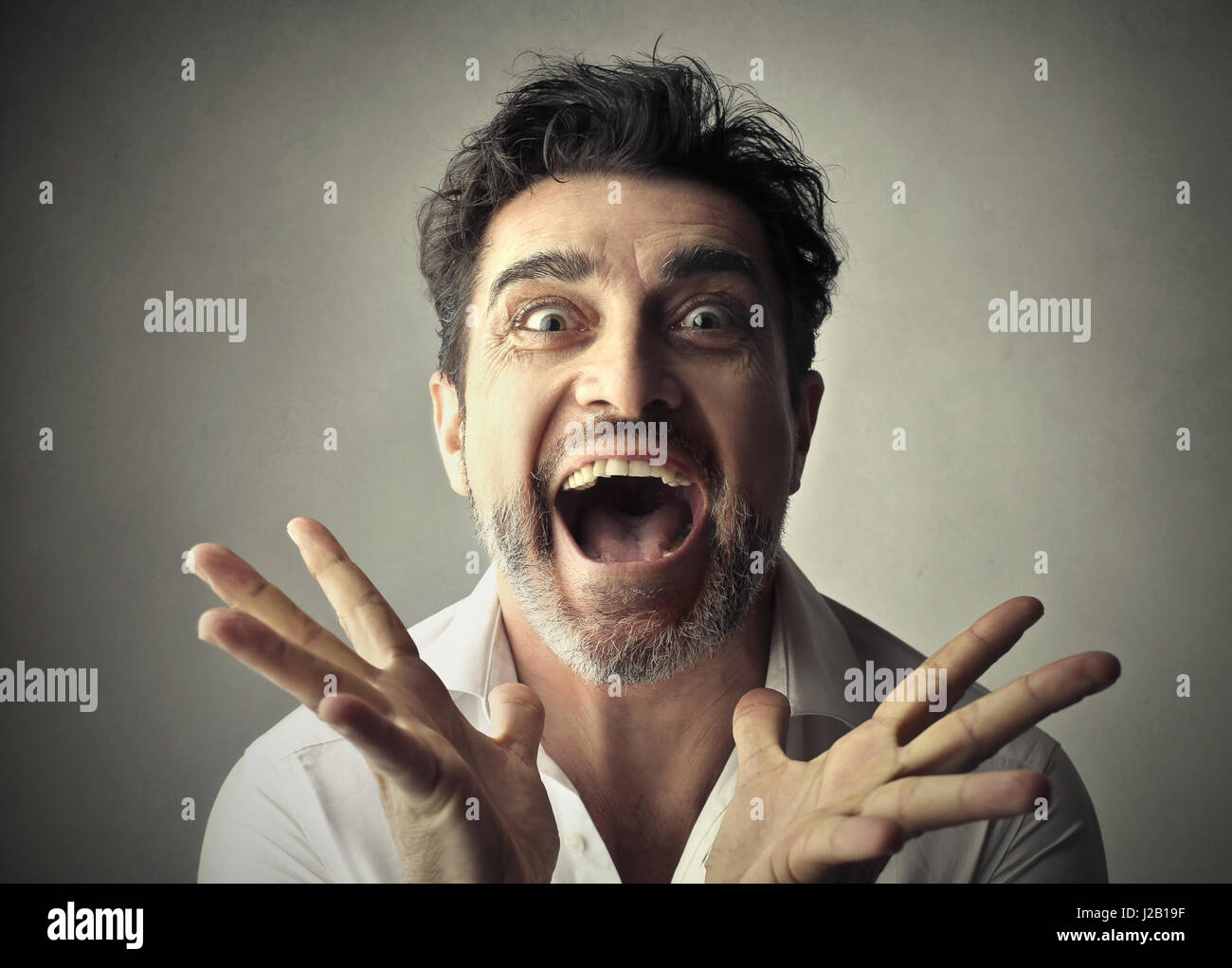 Excited businessman looking into camera Stock Photo