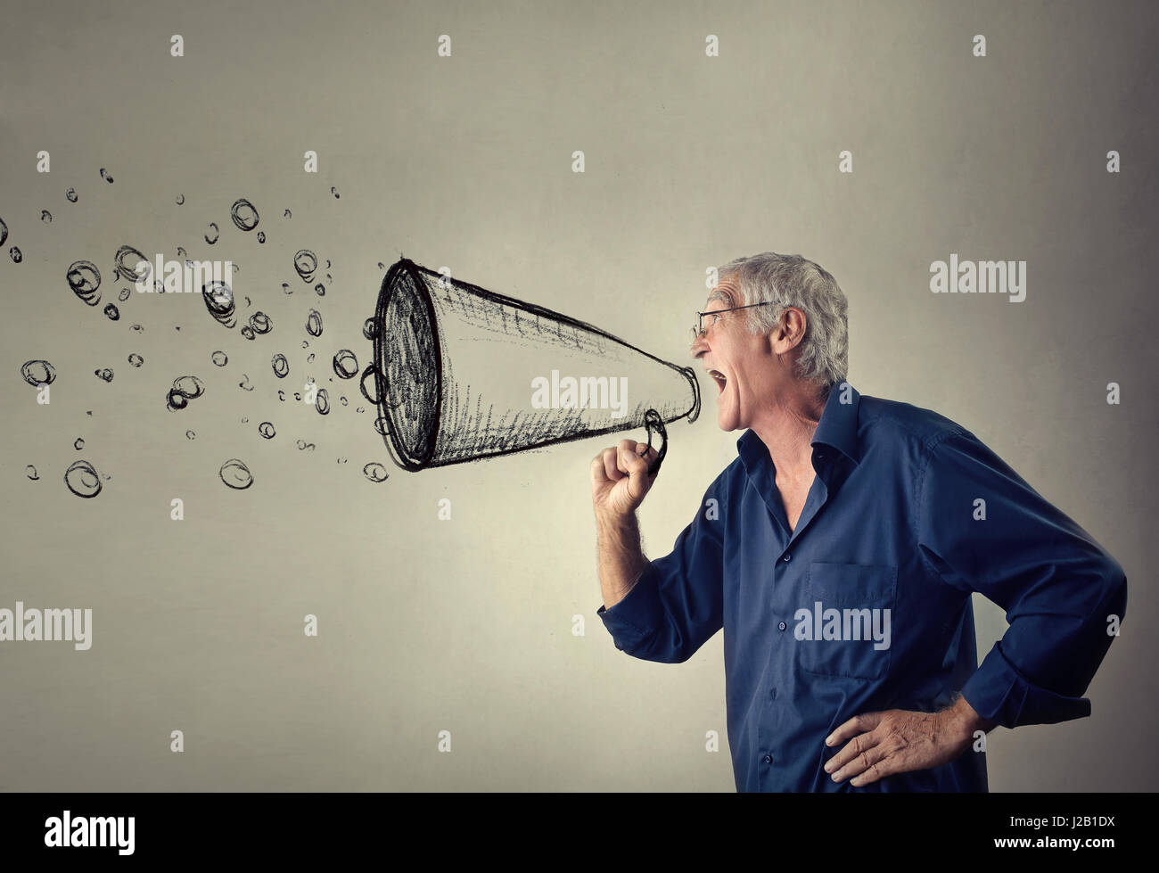 Old man yelling with drawn megaphone Stock Photo