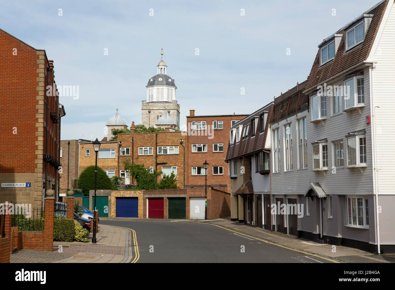 Small side street in Spice Island in old Portsmouth. The top of the Cathedral towering above the apartment buildings. Stock Photo