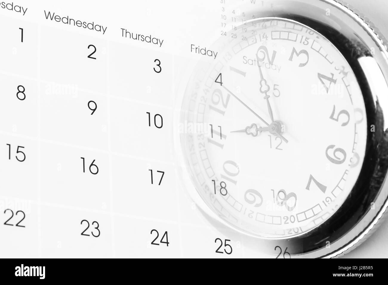 Watch on calendar page numbers Stock Photo