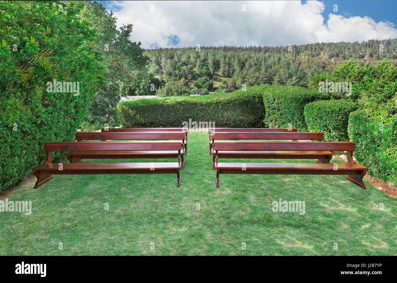Benches with Christian symbols on the green grass for a sermon hearing Stock Photo