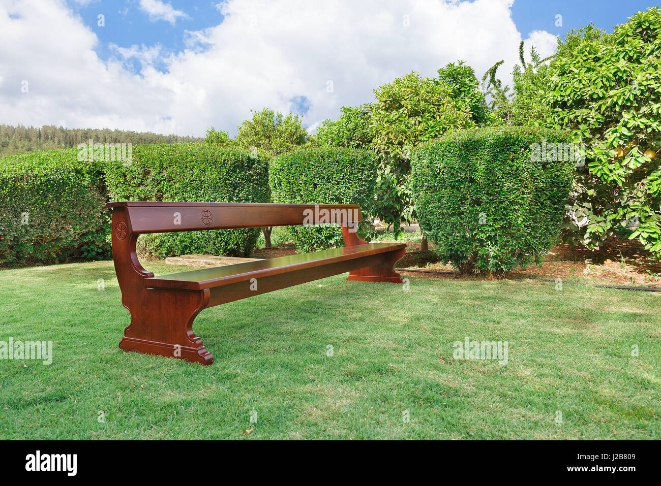 Benches with Christian symbols on the green grass Stock Photo