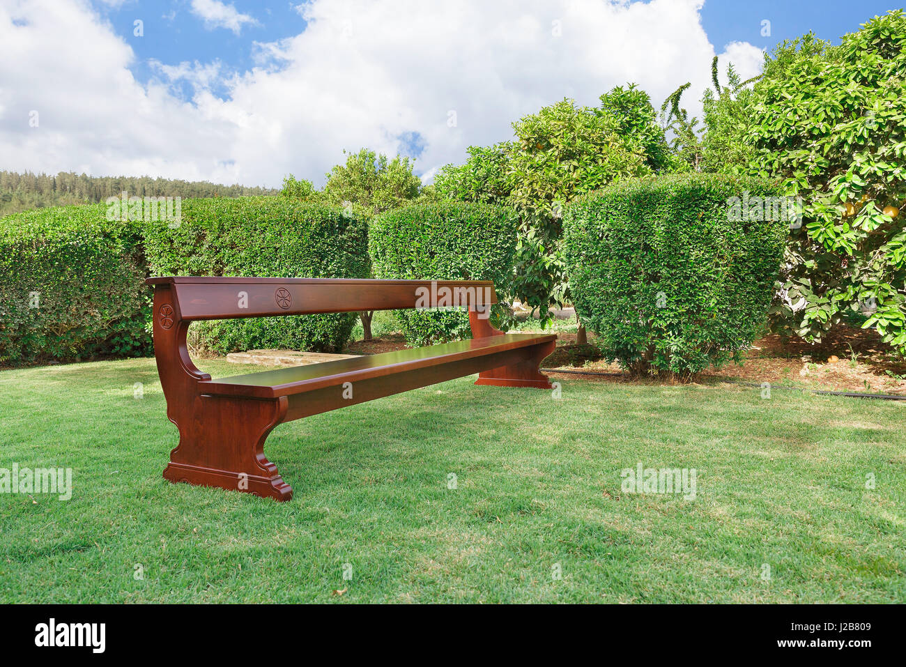 Benches With Christian Symbols On The Green Grass Stock Photo