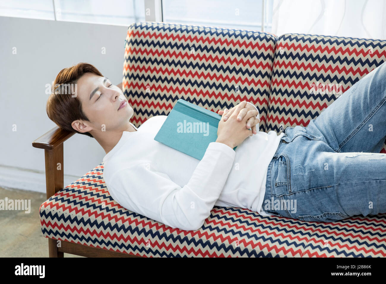 Man sleeping lying down on sofa Stock Photo Alamy