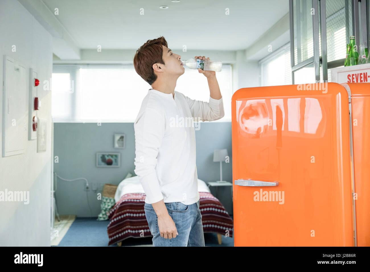 Man drinking cold water from refrigerator Stock Photo Alamy