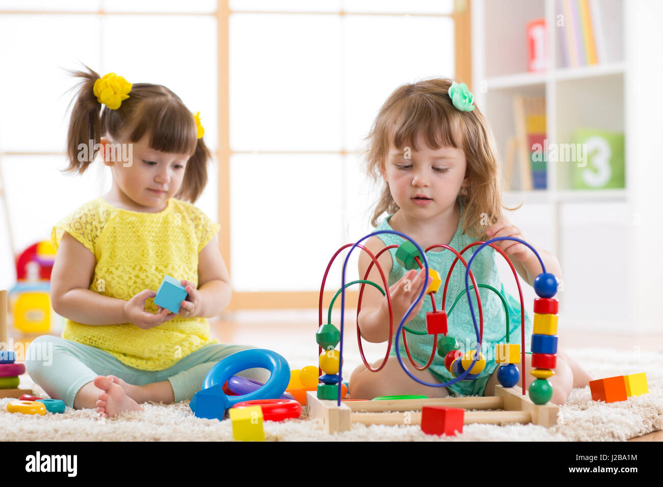 Children playing with toys in kindergarten Stock Photo