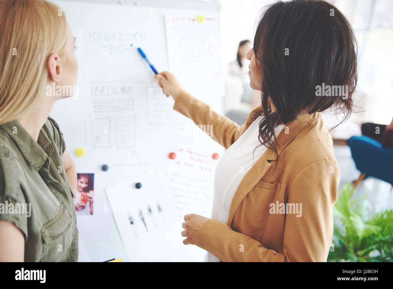 Business woman discussing project with colleague Stock Photo