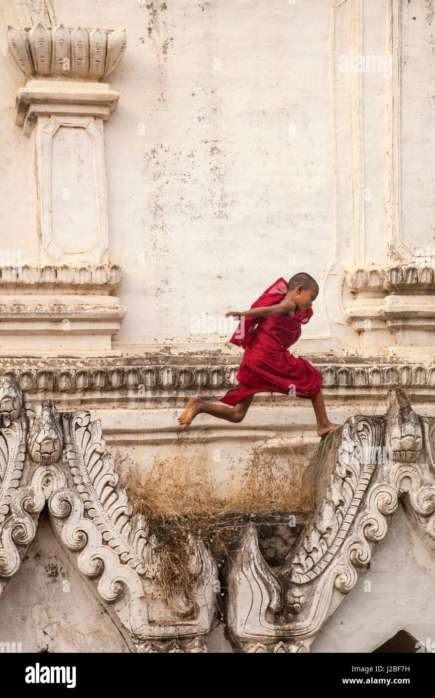 Myanmar, Mandalay. Novice Buddhist monk jumping. Credit as: Jim Zuckerman / Jaynes Gallery / DanitaDelimont.com Stock Photo