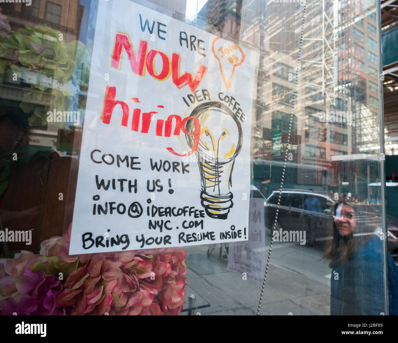 A sign in the window of a Idea Coffee in New York advertises for ...