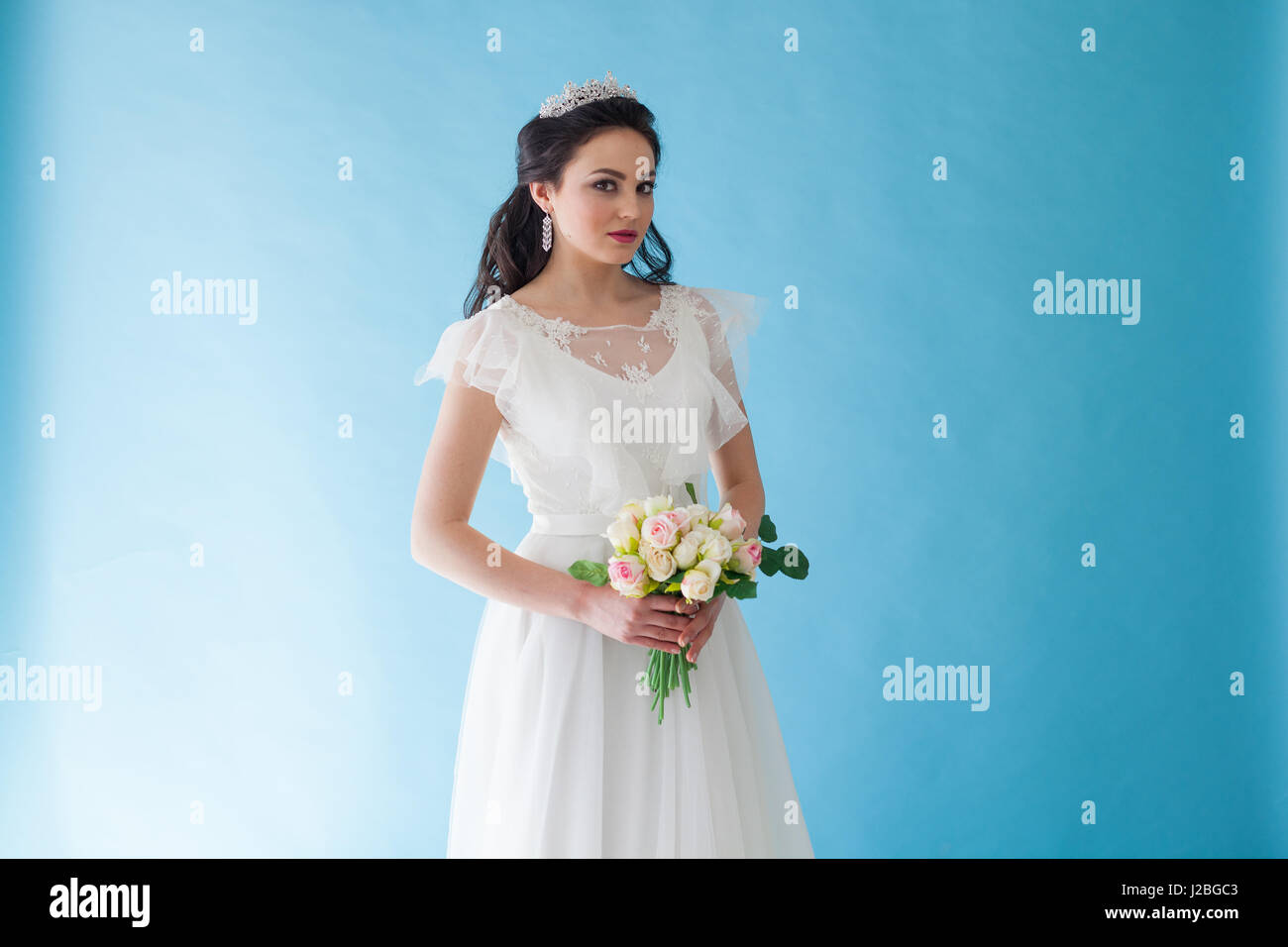 Princess Bride in a white dress with a Crown on a blue background Stock ...