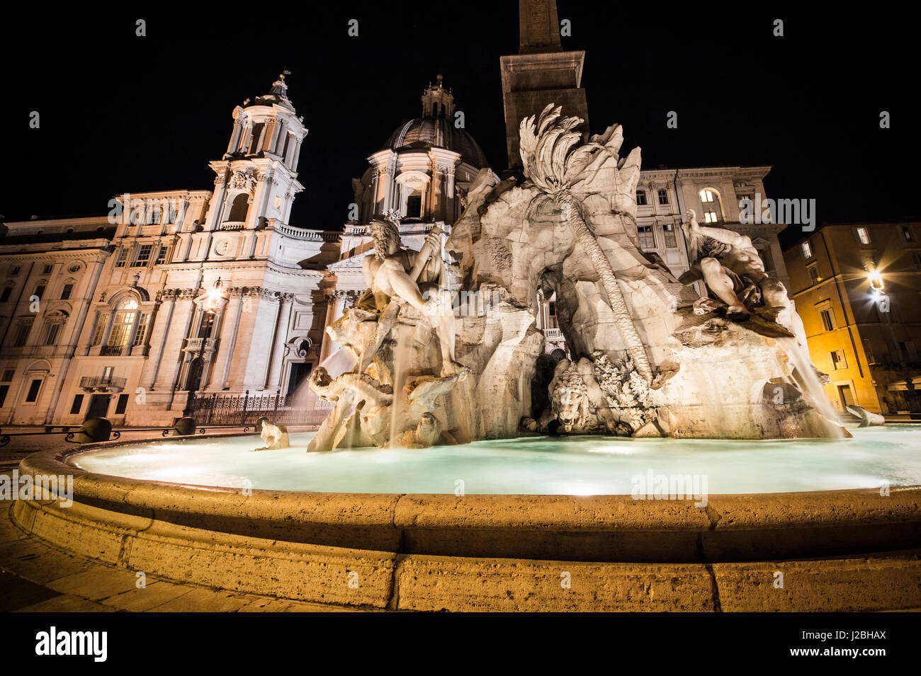 Close view details of the fountain of the four Rivers with Egyptian obelisk by night, Piazza Navona, Rome, Italy Stock Photo