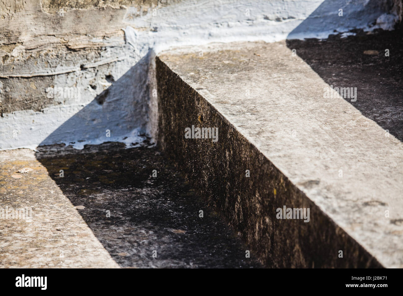 Abstract weathered concrete or cement steps in harsh sunlight - diagonal closeup. Stock Photo
