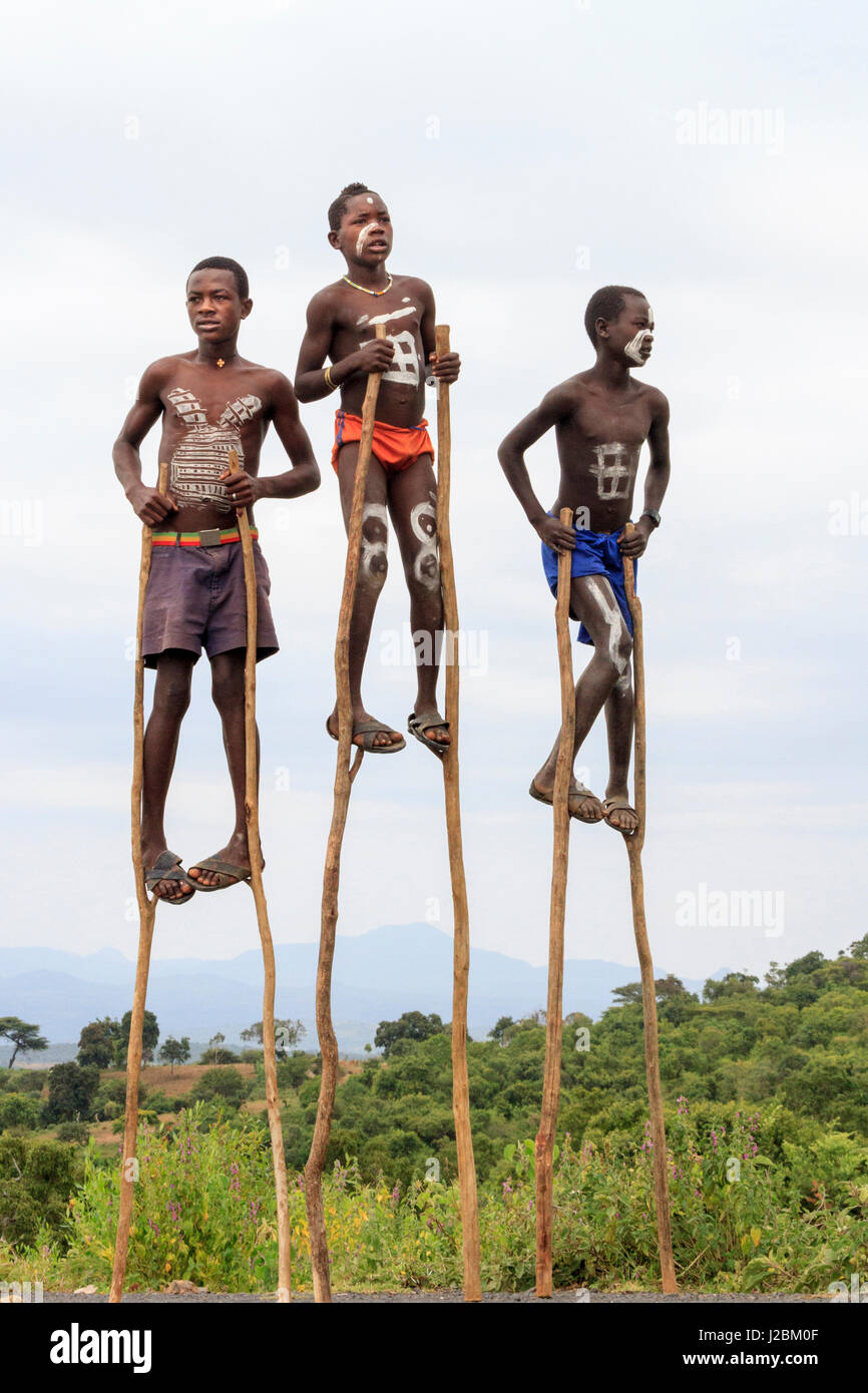 Boys at the wayside balancing on stilts. Jinka. Ethiopia, Africa Stock