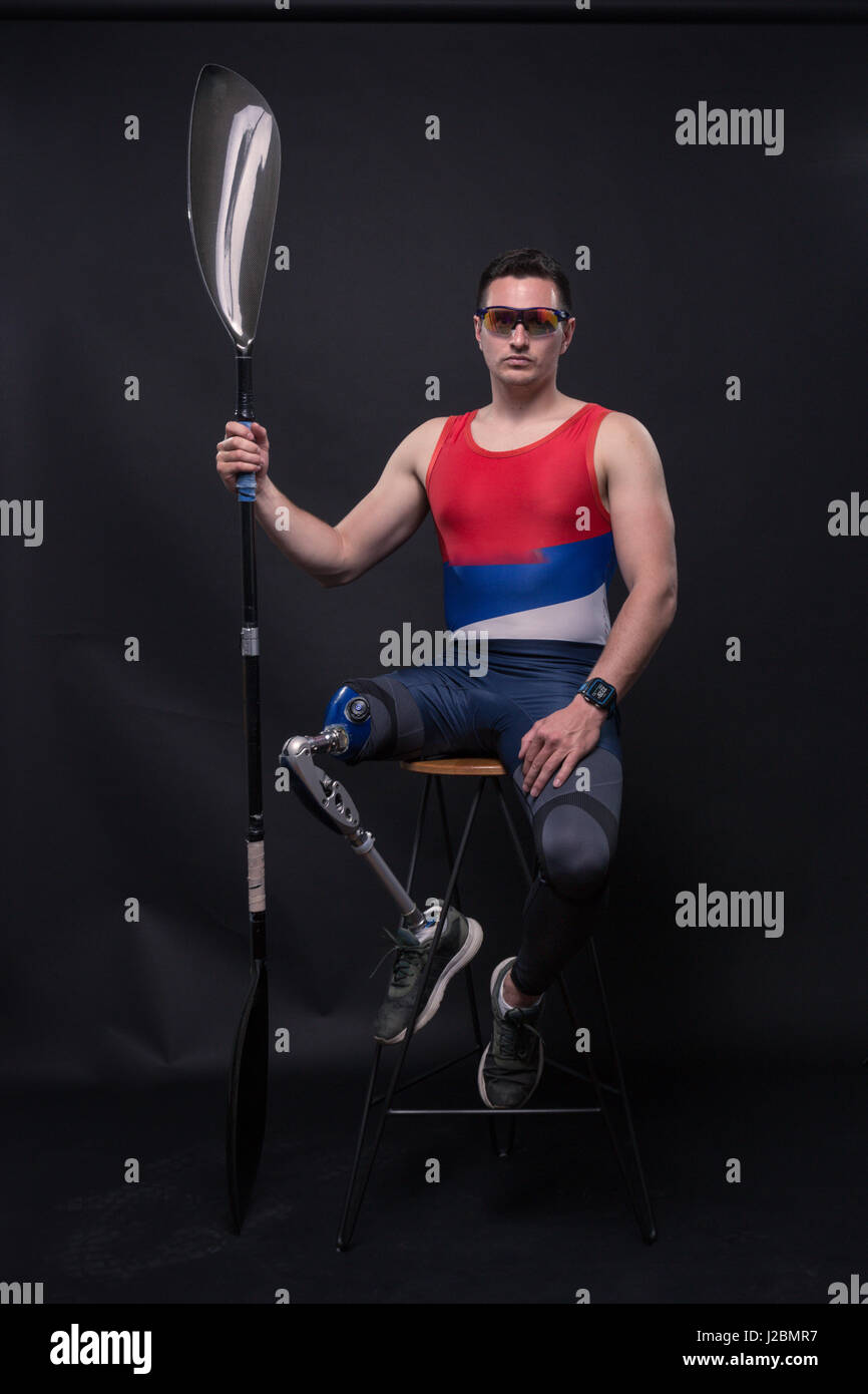 one young adult man only, sitting in bar stool, athlete sporstman canoe